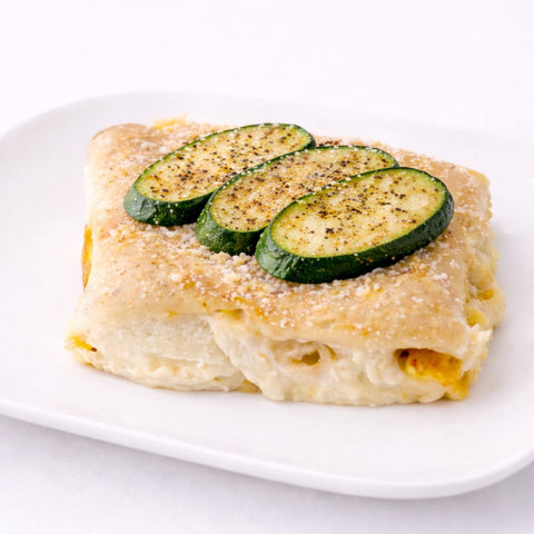 dettaglio di zucchine e besciamella su crespelle vegan